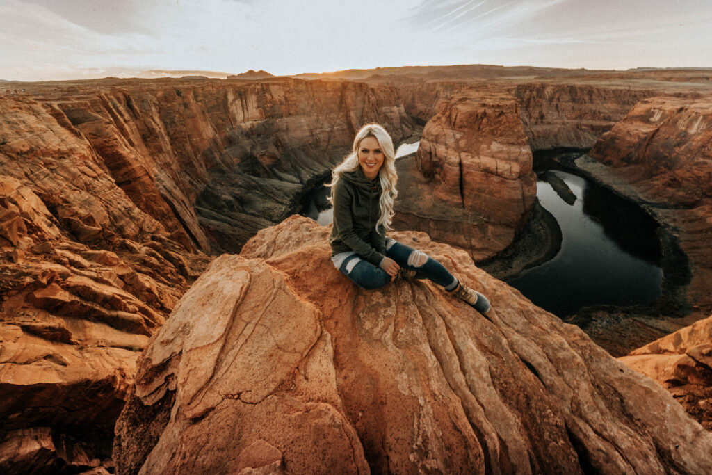 Girl Sitting at Horseshoe Bend in Page Arizona at Sunset